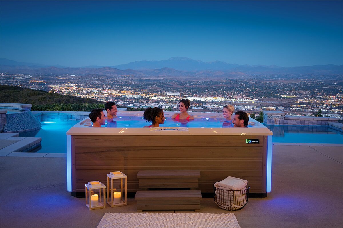 A cozy evening soak in a premium Hot Spring spa, illustrating the affordability and features of modern hot tubs.