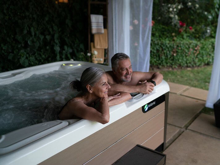 A couple enjoying a peaceful soak in their hot tub, thanks to simple chlorine maintenance.