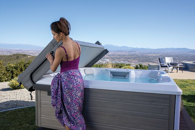 A cover lifter makes getting into and out of a hot tub easier.
