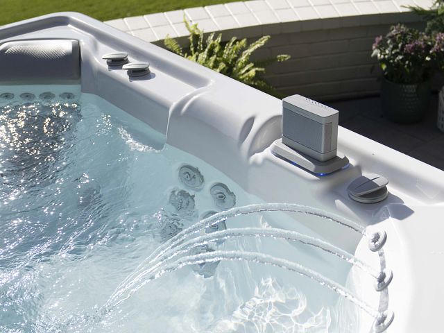 An elegant Hot Spring spa in a modern backyard, emphasizing the value of investing in a high-quality hot tub.